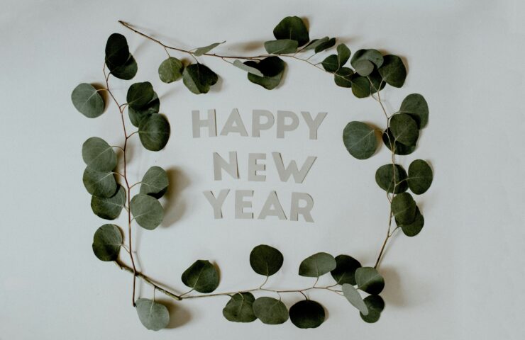 Happy New Year letters surrounded by Eucalyptus branches